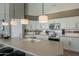 Bright kitchen featuring a large island with pendant lights, white cabinets, and stainless steel appliances at 6334 E Viewmont Dr # 29, Mesa, AZ 85215