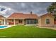 A well-maintained backyard featuring artificial turf, a covered patio, and desert landscaping at 657 N Marble St, Gilbert, AZ 85234