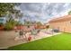Large backyard with an outdoor dining and seating area and a storage shed at 657 N Marble St, Gilbert, AZ 85234