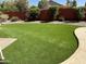 Expansive backyard featuring well-maintained artificial turf and desert landscaping, perfect for outdoor activities and entertaining at 657 N Marble St, Gilbert, AZ 85234