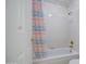 Bright bathroom featuring a white tiled shower-tub combo with a colorful curtain at 657 N Marble St, Gilbert, AZ 85234