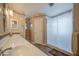 Well-lit bathroom with dual sinks, decorative wall trim, and a shower behind a curtain at 657 N Marble St, Gilbert, AZ 85234