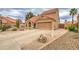 Charming two-story home featuring a Spanish tile roof and a two-car garage with a private front patio at 657 N Marble St, Gilbert, AZ 85234