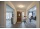Inviting foyer featuring tile flooring, natural light, and offers a glimpse into other rooms at 657 N Marble St, Gilbert, AZ 85234