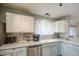 Kitchen boasts stainless steel appliances, light blue cabinets, and ample counter space at 657 N Marble St, Gilbert, AZ 85234