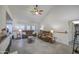 Inviting living room with plush sofas, a ceiling fan, and natural light from the windows at 657 N Marble St, Gilbert, AZ 85234