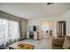 Open living room featuring tile floors, a cozy fireplace, and access to other rooms at 657 N Marble St, Gilbert, AZ 85234