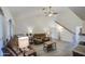 Cozy living room with comfortable seating, a ceiling fan, and access to the staircase at 657 N Marble St, Gilbert, AZ 85234