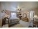 Spacious main bedroom with a ceiling fan and ensuite bath at 657 N Marble St, Gilbert, AZ 85234