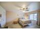 Spacious main bedroom with a ceiling fan and ensuite bath at 657 N Marble St, Gilbert, AZ 85234
