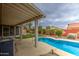 Backyard view featuring a pool with a covered patio, landscaping, and a serene atmosphere at 657 N Marble St, Gilbert, AZ 85234