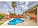 Sparkling pool in a backyard with desert landscaping, a covered patio, and mature trees at 657 N Marble St, Gilbert, AZ 85234