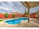 Backyard pool area with desert landscaping, mature trees, and a covered patio for outdoor living at 657 N Marble St, Gilbert, AZ 85234
