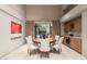 Dining area featuring a modern table with seating for six, a bar, and a large window with natural light at 7380 E Turquoise Ave, Scottsdale, AZ 85258