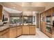 Open kitchen featuring granite counters, stainless appliances, and a breakfast bar at 7380 E Turquoise Ave, Scottsdale, AZ 85258
