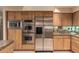 Modern kitchen with stainless steel appliances, custom cabinets and granite counters at 7380 E Turquoise Ave, Scottsdale, AZ 85258