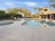 Beautiful pool and spa area featuring lounge chairs, palm trees, and a covered structure at 7380 E Turquoise Ave, Scottsdale, AZ 85258