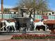 Elaborate fountain with white horse statues surrounded by red flowers at 7642 E Pasadena Ave, Scottsdale, AZ 85250