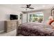 Well-lit main bedroom boasts carpet, a ceiling fan, and large windows with a view at 7642 E Pasadena Ave, Scottsdale, AZ 85250