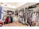 Walk-in closet features custom shelves, clothing racks, and hardwood flooring for organized and stylish storage at 8003 E Sands Dr, Scottsdale, AZ 85255