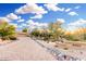 Beautiful desert landscaping and paver driveway leading up to this charming home, with a beautiful blue sky overhead at 8003 E Sands Dr, Scottsdale, AZ 85255