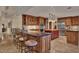 Spacious kitchen featuring custom cabinets, stainless steel appliances, and a breakfast bar with counter seating at 8003 E Sands Dr, Scottsdale, AZ 85255