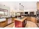 Modern kitchen with granite countertops, stainless steel appliances, and a center island with a butcher block top at 8003 E Sands Dr, Scottsdale, AZ 85255