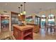 Bright kitchen with stainless steel appliances, wooden cabinetry, and a center island, offering a functional layout at 8003 E Sands Dr, Scottsdale, AZ 85255