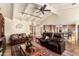 Inviting living room with vaulted ceilings, comfortable leather seating, and a view into the adjacent gourmet kitchen at 8003 E Sands Dr, Scottsdale, AZ 85255