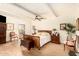 Comfortable main bedroom with wood floors, a ceiling fan, and access to a private patio at 8003 E Sands Dr, Scottsdale, AZ 85255