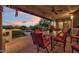 Covered patio with an outdoor dining table and view of the sparkling pool at 8003 E Sands Dr, Scottsdale, AZ 85255