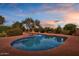 Inviting swimming pool with a sun-soaked patio and lush landscaping at 8003 E Sands Dr, Scottsdale, AZ 85255
