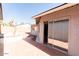 Backyard patio with sliding glass door and neutral walls with a view to the yard at 8666 E Fillmore St, Scottsdale, AZ 85257
