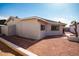 View of a neutral colored home with gravel landscaping in backyard with window at 8666 E Fillmore St, Scottsdale, AZ 85257