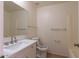 Modern bathroom featuring a vanity with a sink, white tiling, and neutral walls at 8666 E Fillmore St, Scottsdale, AZ 85257