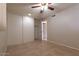 Bedroom with large closet, ceiling fan, tile floor and neutral walls at 8666 E Fillmore St, Scottsdale, AZ 85257