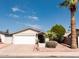 Charming single-story home featuring a well-maintained front yard with mature trees and a two-car garage at 8666 E Fillmore St, Scottsdale, AZ 85257