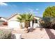 Landscaped front yard with a decorative palm tree and well manicured shrubs at 8666 E Fillmore St, Scottsdale, AZ 85257