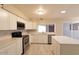 Bright kitchen features white cabinets, stainless steel appliances, and a modern backsplash at 8666 E Fillmore St, Scottsdale, AZ 85257