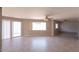 Spacious living room with tile flooring, ceiling fan and natural light from sliding glass door at 8666 E Fillmore St, Scottsdale, AZ 85257