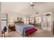 Spacious main bedroom with a plush bed, mirrored closet doors, and natural light creating a serene retreat at 9445 W Taro Ln, Peoria, AZ 85382