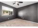 A carpeted bedroom with a large window and dark-grey painted walls at 984 W Hudson Way, Gilbert, AZ 85233