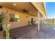 Extended covered patio with ceiling fans and beautiful brick pavers offering ample space for outdoor living at 984 W Hudson Way, Gilbert, AZ 85233