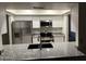 Modern kitchen features stainless steel appliances, granite counters, and white cabinets at 10014 N 44Th Dr, Glendale, AZ 85302