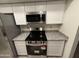 Close-up of the kitchen's stainless steel oven and microwave, complemented by granite countertops at 10014 N 44Th Dr, Glendale, AZ 85302
