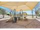 A community playground features slides and play equipment under a shade structure, creating a fun, safe environment at 10410 W Patrick Ln, Peoria, AZ 85383