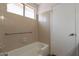 Well-lit bathroom with a bathtub and tiled walls, providing a clean and functional space at 10647 N 63Rd Dr, Glendale, AZ 85304