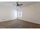 Neutral bedroom with a ceiling fan, window and neutral carpeted flooring at 10647 N 63Rd Dr, Glendale, AZ 85304