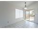 Bright dining area with tile flooring, modern lighting, and sliding glass doors at 10647 N 63Rd Dr, Glendale, AZ 85304