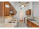 Cozy kitchen featuring matching cabinets, a white stovetop and neutral tile backsplash at 10647 N 63Rd Dr, Glendale, AZ 85304